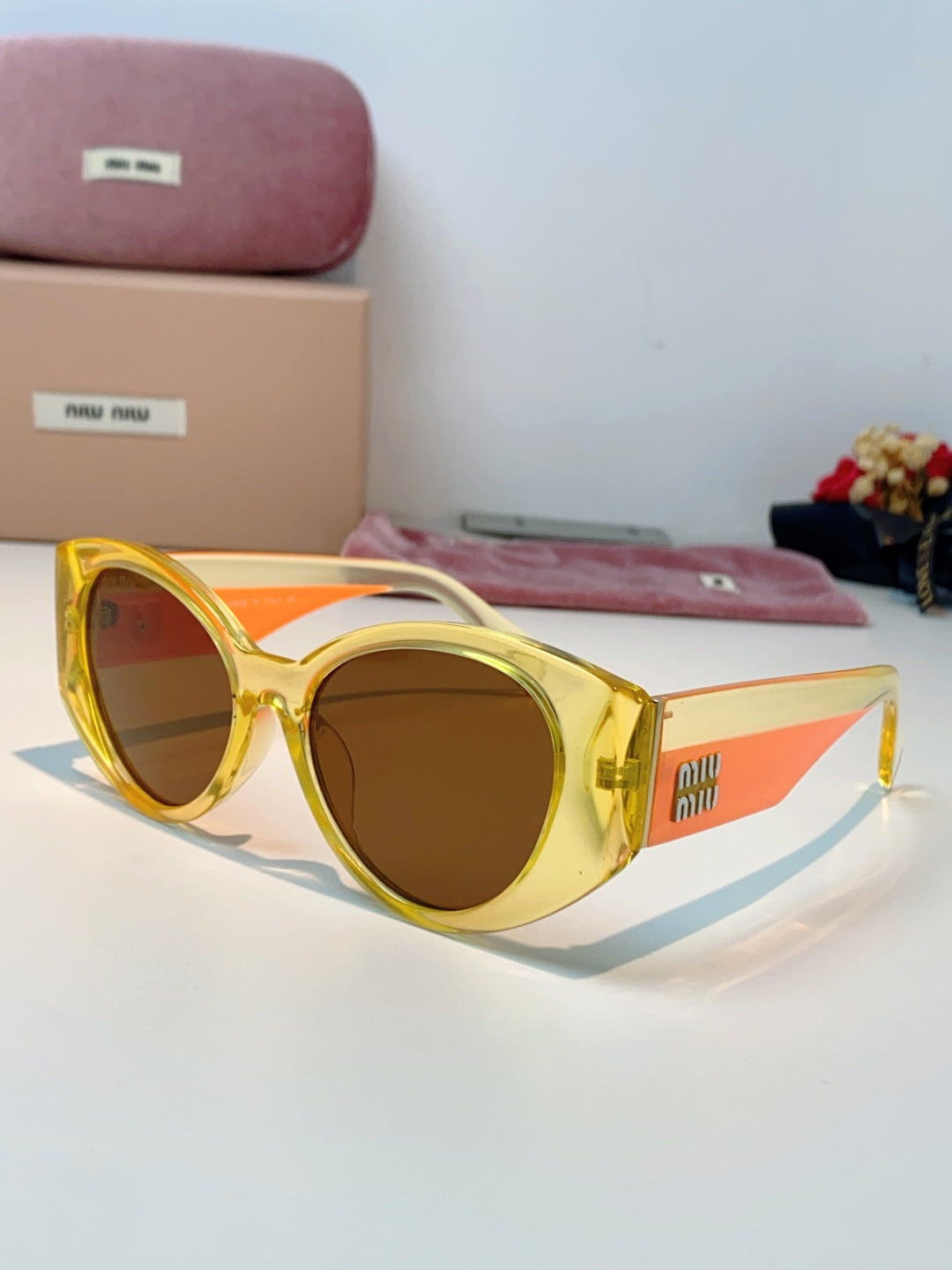 Miu Miu Polarized Cat-Eye Orange Lens Sunglasses for Men & Women