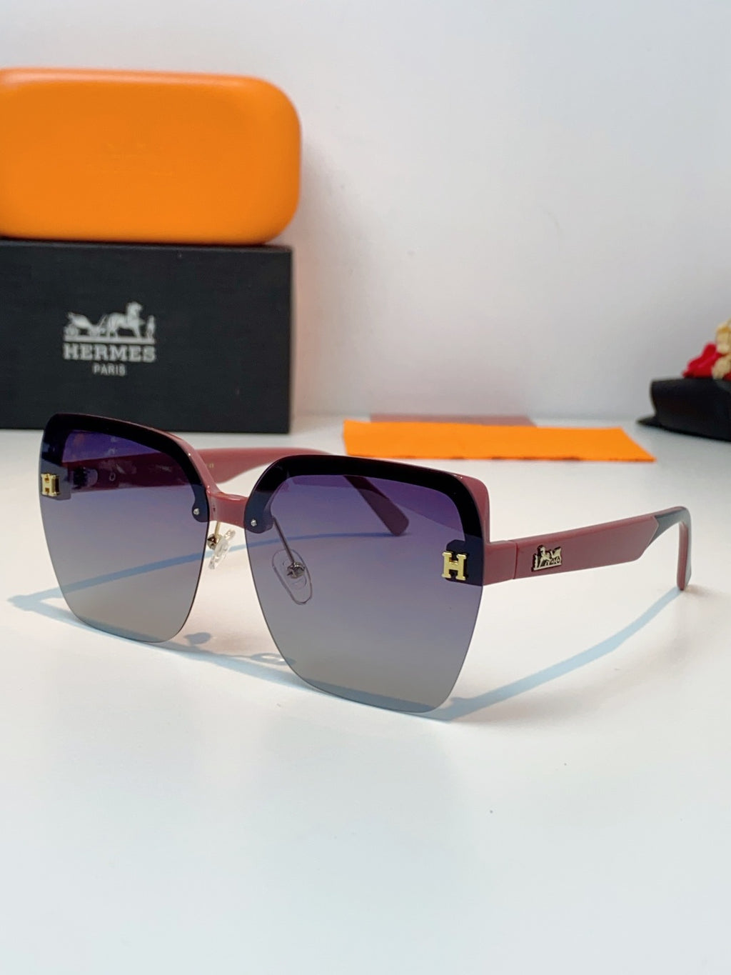 Hermès Lightweight Rimless Red Lens Sunglasses for Men & Women